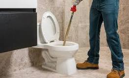 How do you unclog a toilet with an auger?