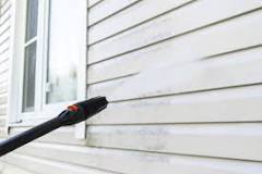 How long should you wait to paint a house after power washing?
