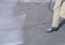 What do you spray on concrete after pouring it?