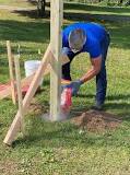 What do you use to dig holes in a fence post?