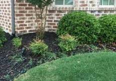 How do I stop grass from creeping in my flower beds?