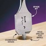 How do you make a hole bigger with a spade bit?