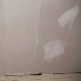 Should drywall touch the floor?