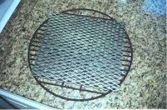 How do you keep charcoal from falling through the grates?