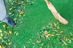 How do you remove small debris from artificial grass?