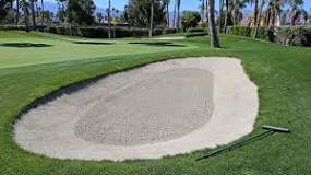 Why do golfers rake the sand?